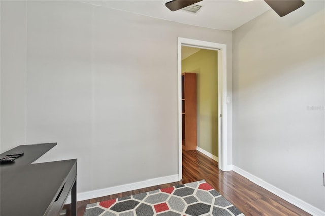 home office with dark hardwood / wood-style floors and ceiling fan