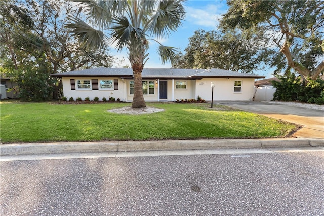 ranch-style home featuring a front yard