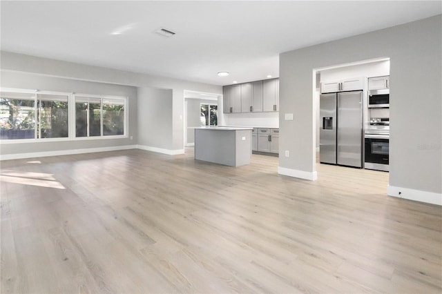 unfurnished living room featuring light wood-type flooring