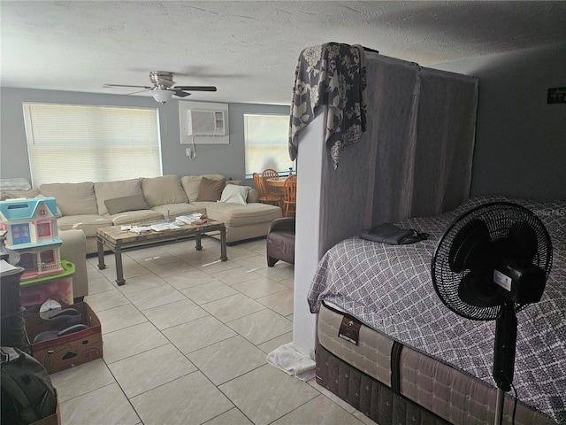 tiled living room with a wealth of natural light, ceiling fan, a textured ceiling, and a wall mounted AC