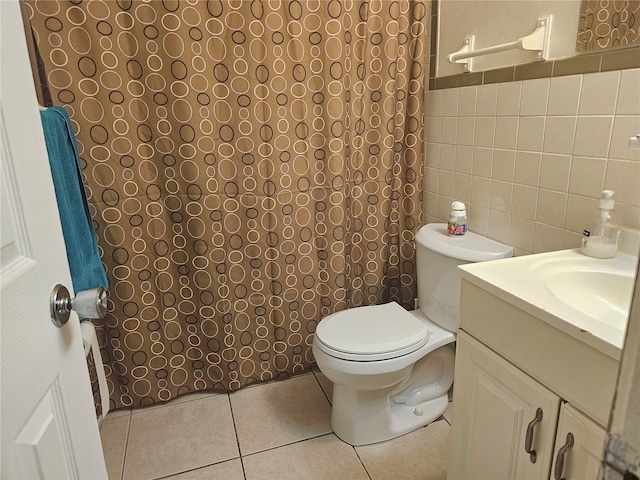 bathroom with vanity, tile patterned flooring, toilet, and tile walls