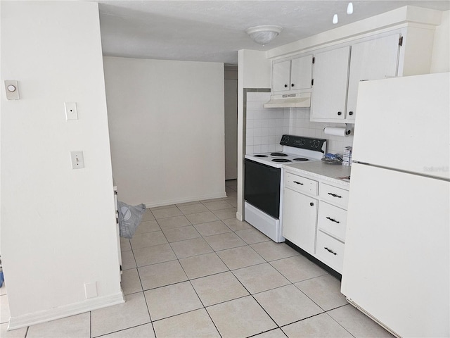 kitchen featuring tasteful backsplash, white appliances, light tile patterned floors, and white cabinets