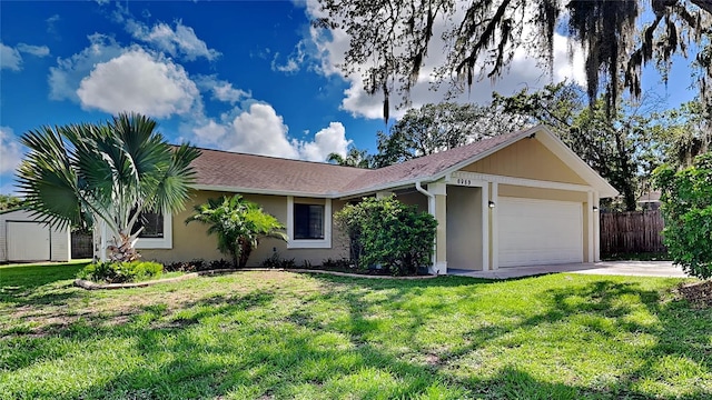 single story home featuring a front yard and a garage