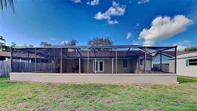 back of property featuring a yard, a lanai, and french doors