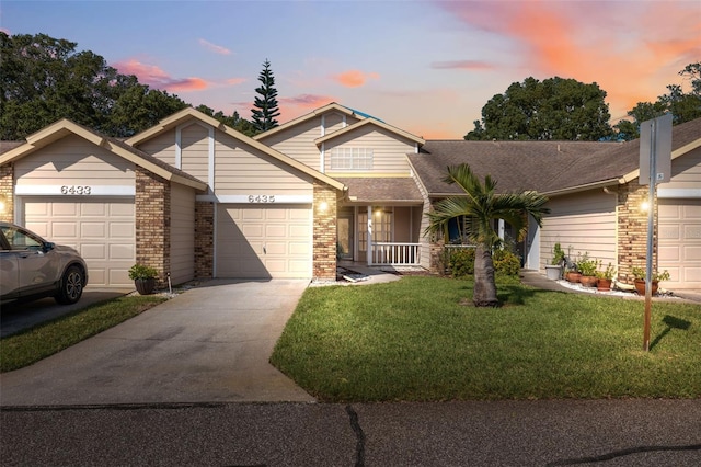 view of front facade with a yard and a garage