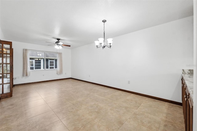 unfurnished room with ceiling fan with notable chandelier