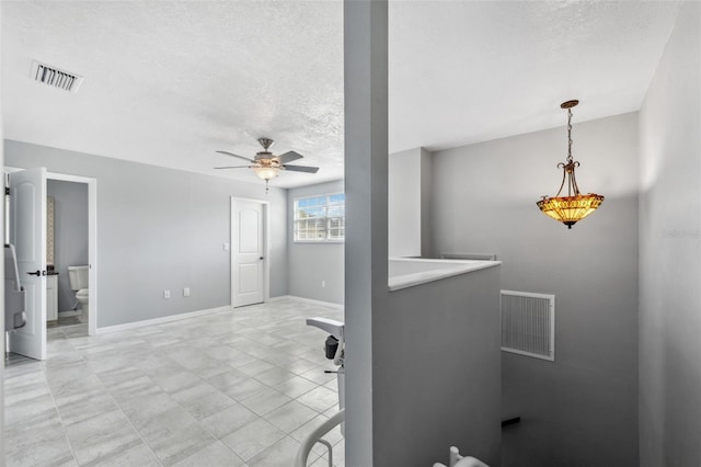 interior space featuring a textured ceiling and ceiling fan