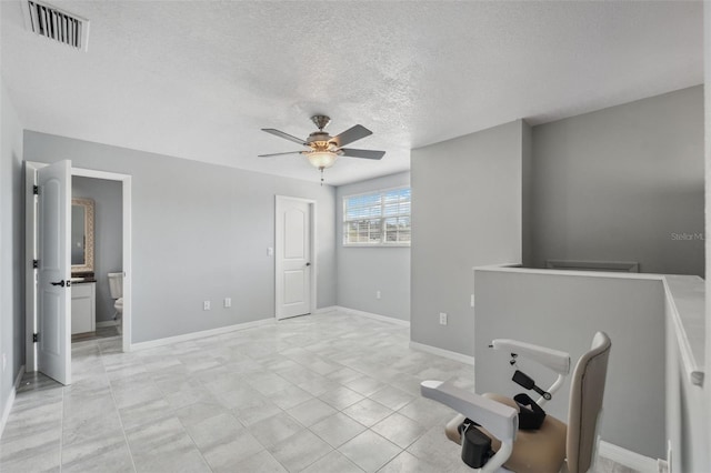 interior space featuring ceiling fan and a textured ceiling