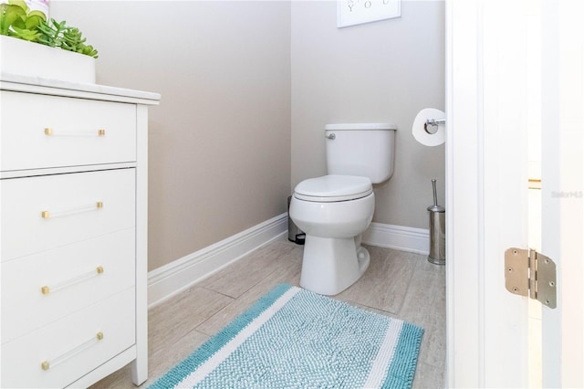 bathroom with toilet and wood-type flooring