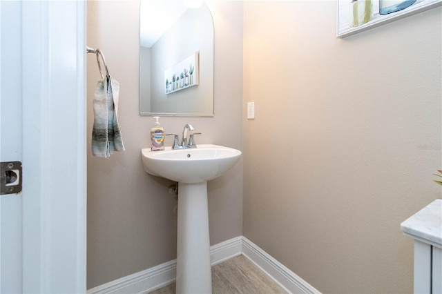 bathroom with hardwood / wood-style floors