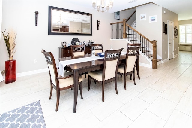 dining room with a notable chandelier and light tile patterned floors