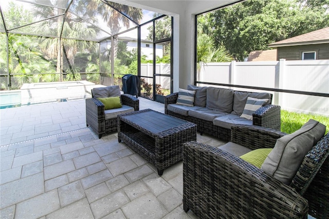 view of patio / terrace with an outdoor hangout area and glass enclosure