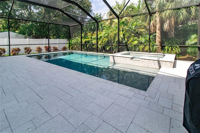 view of swimming pool with a patio area, a lanai, and an in ground hot tub