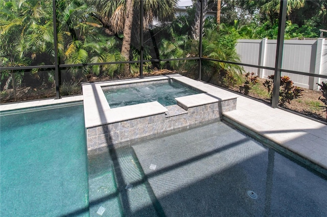 view of swimming pool featuring an in ground hot tub