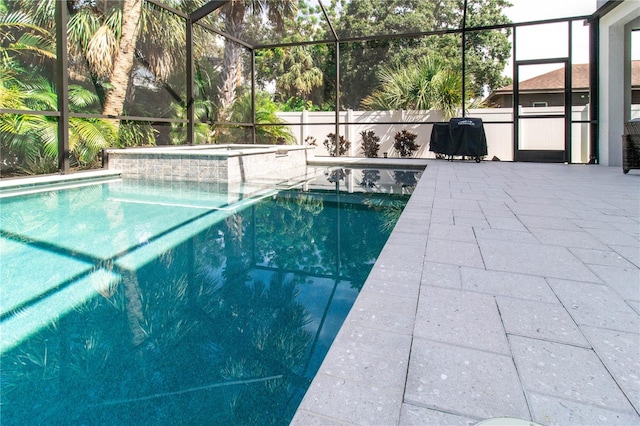 view of swimming pool featuring an in ground hot tub, a patio, and glass enclosure