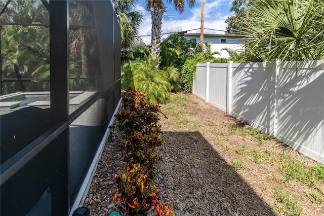 view of yard with glass enclosure