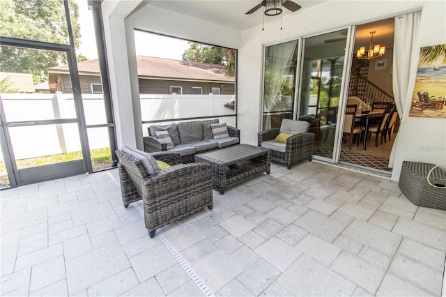 sunroom featuring ceiling fan