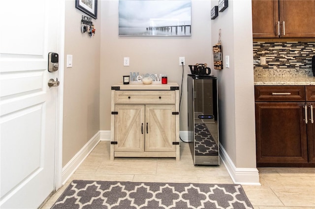 bathroom featuring decorative backsplash and tile patterned flooring