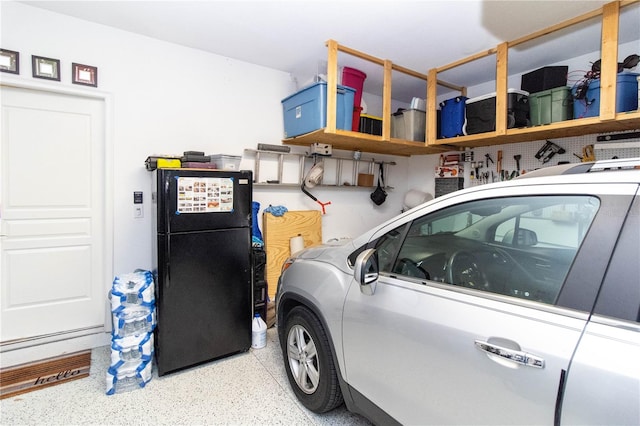 garage with black fridge