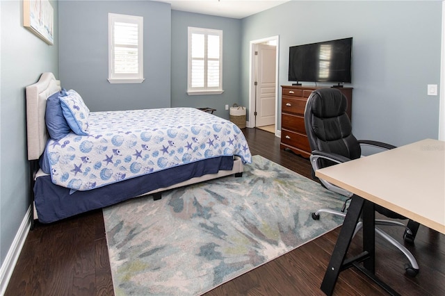 bedroom with dark hardwood / wood-style floors