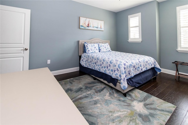 bedroom with dark wood-type flooring