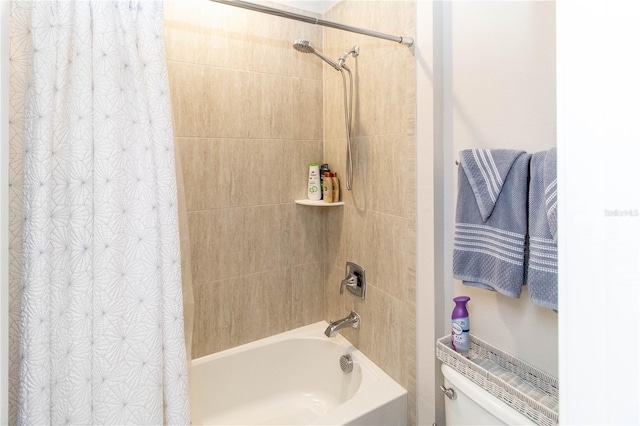 bathroom featuring shower / bath combination with curtain and toilet