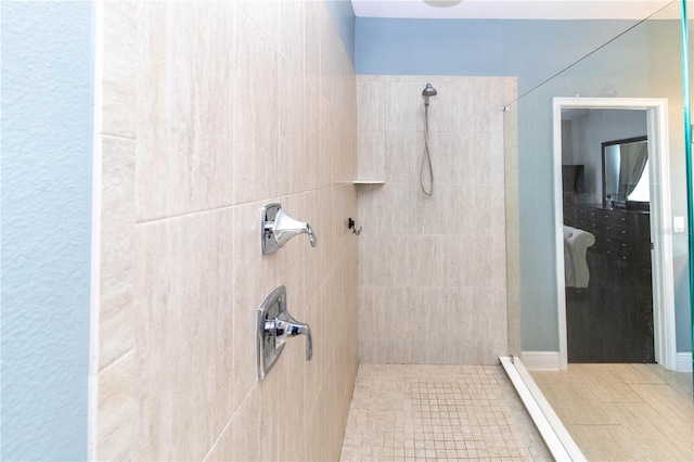 bathroom featuring tile patterned floors and tiled shower