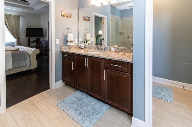 bathroom with vanity, walk in shower, and tile patterned flooring