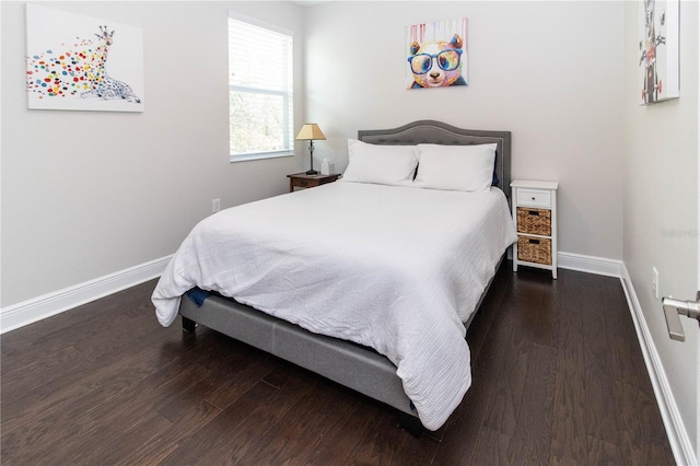 bedroom with dark hardwood / wood-style flooring