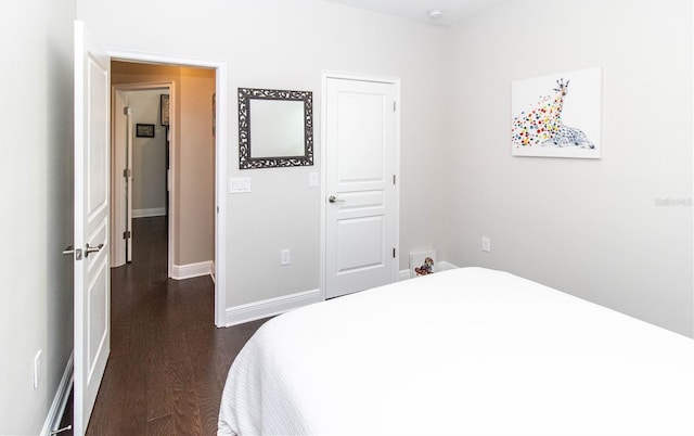 bedroom with dark wood-type flooring