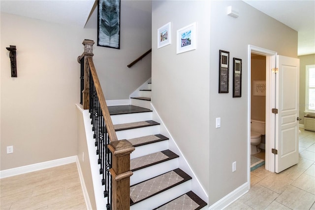 stairway with tile patterned floors