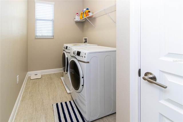 laundry area featuring light hardwood / wood-style flooring and washer and dryer