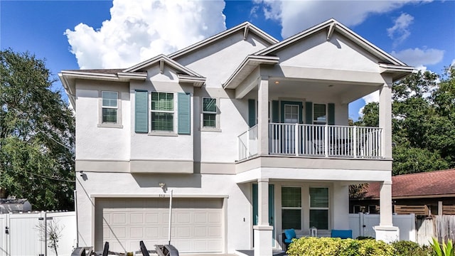 view of front of house featuring a garage and a balcony