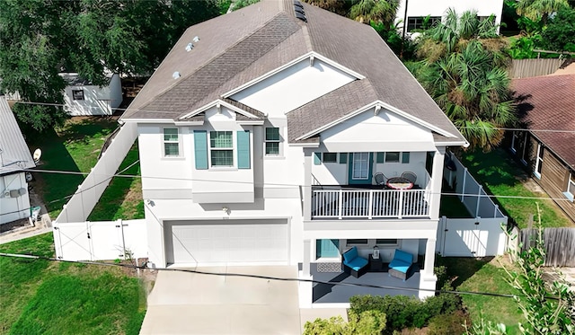 rear view of house featuring a lawn and a garage