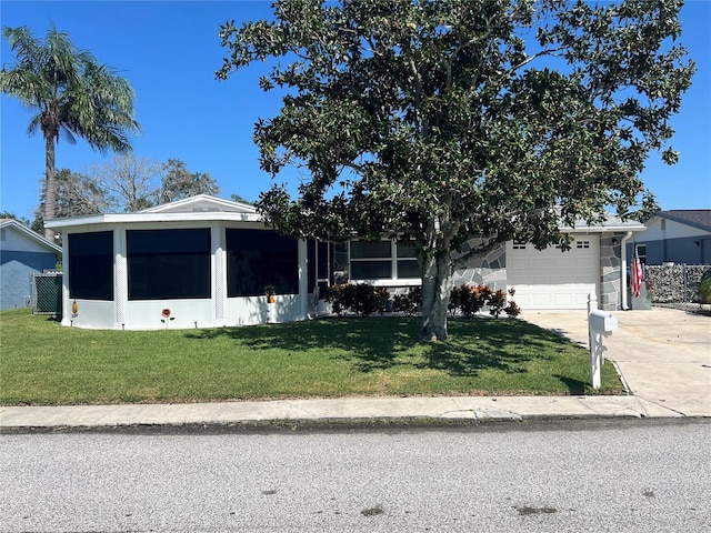 view of front of home with a garage and a front lawn