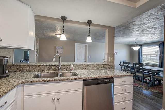 kitchen with dishwasher, sink, white cabinets, dark hardwood / wood-style flooring, and light stone counters