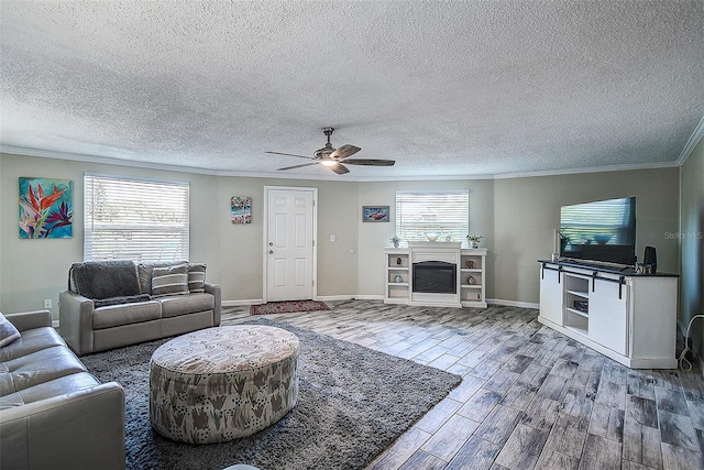 living room featuring crown molding, hardwood / wood-style floors, a textured ceiling, and ceiling fan