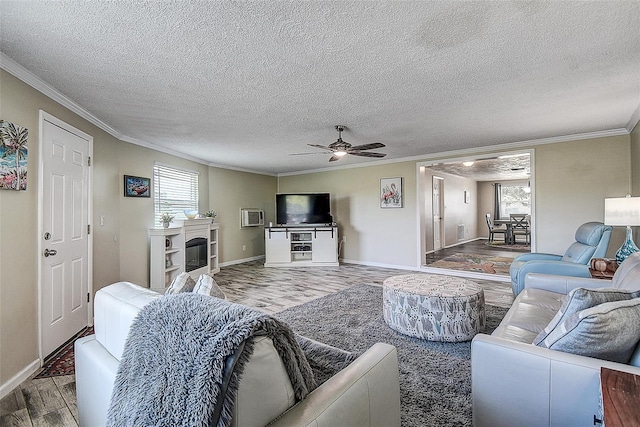 living room with ceiling fan, ornamental molding, and wood-type flooring