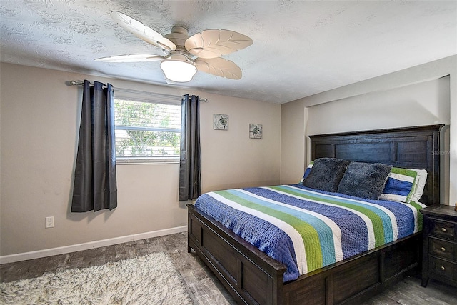 bedroom featuring hardwood / wood-style flooring, a textured ceiling, and ceiling fan