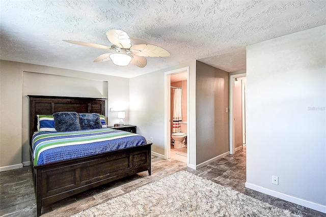 bedroom with ceiling fan, connected bathroom, hardwood / wood-style floors, and a textured ceiling