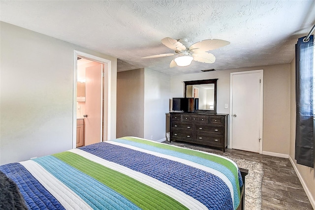 bedroom with dark wood-type flooring, ceiling fan, and a textured ceiling