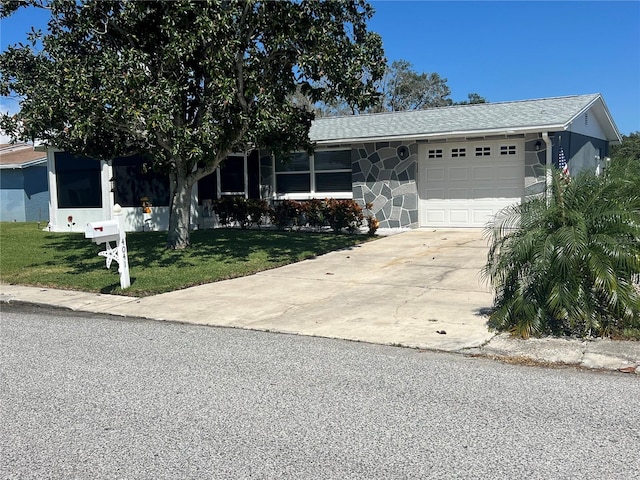 view of front of home featuring a garage and a front lawn