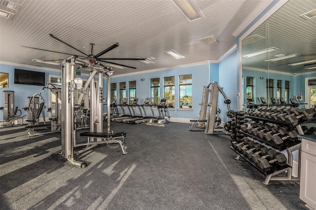 exercise room featuring ornamental molding and a ceiling fan