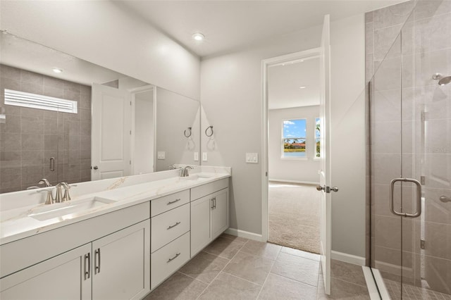 full bathroom with double vanity, a shower stall, tile patterned floors, baseboards, and recessed lighting