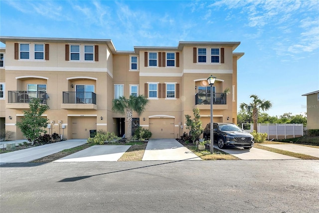 view of property featuring a balcony and a garage