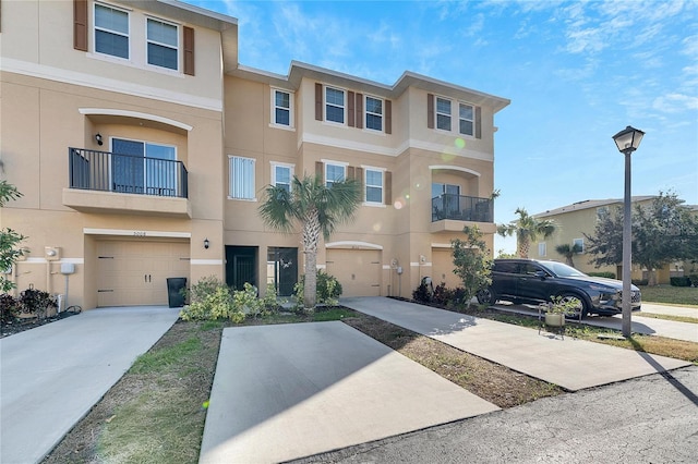 multi unit property featuring a balcony and a garage