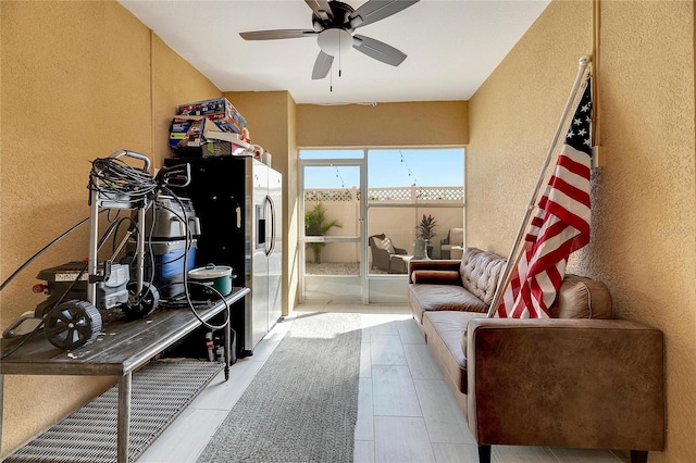 sitting room featuring ceiling fan