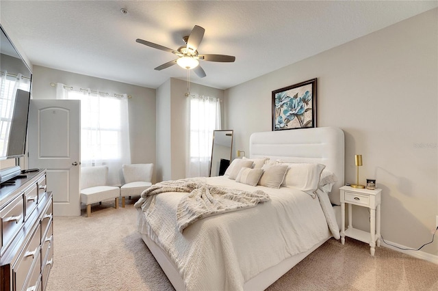 carpeted bedroom with a textured ceiling and ceiling fan