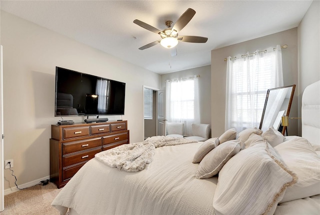 bedroom featuring ceiling fan and light colored carpet