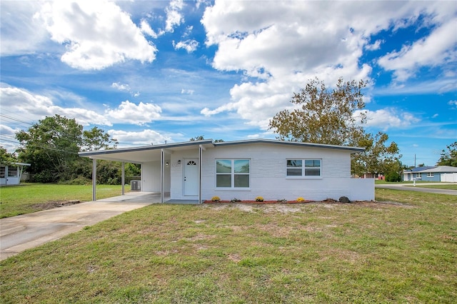 view of front facade with a front yard and a carport